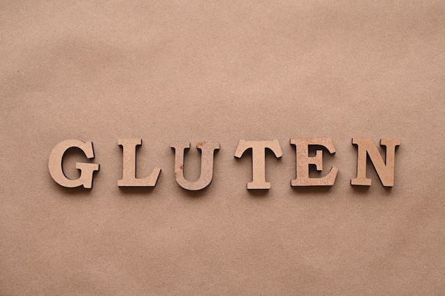 Gluten.Text in block letters on a paper background. Free space for design.